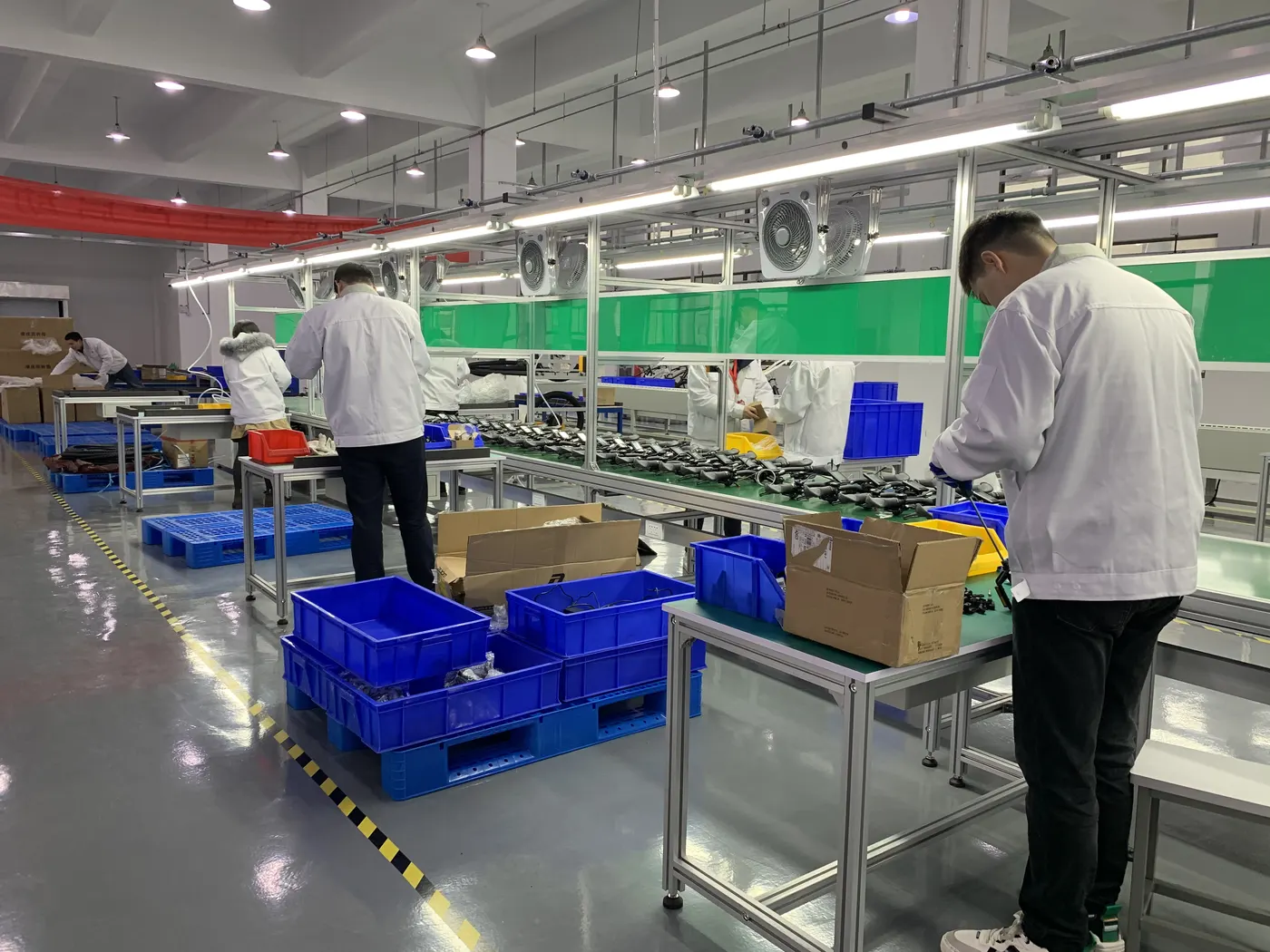 Workers on the PanzeeRoad assembly line in Suzhou